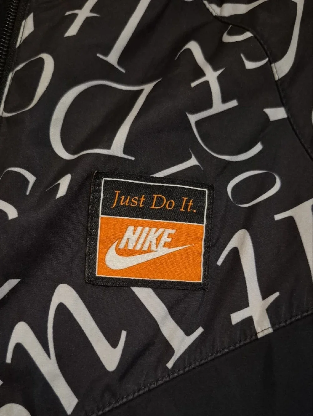 Nike Kids Black Hooded Windbreaker Jacket with White Script Accent